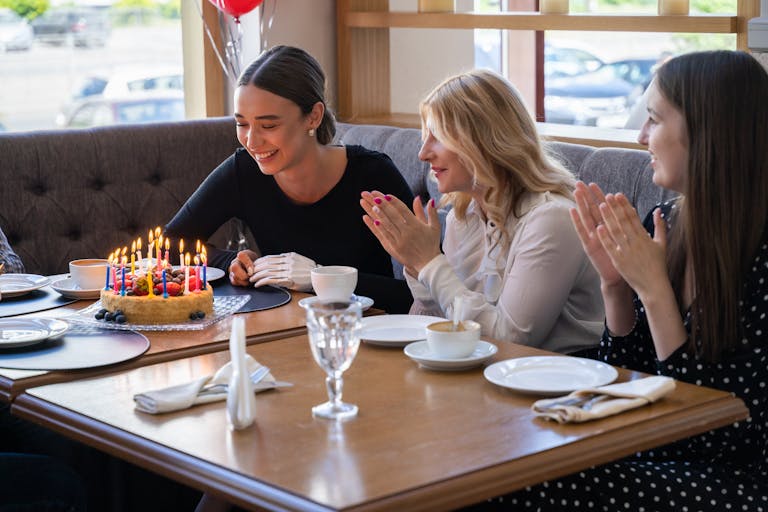 Happy Woman looking at her Birthday Cake