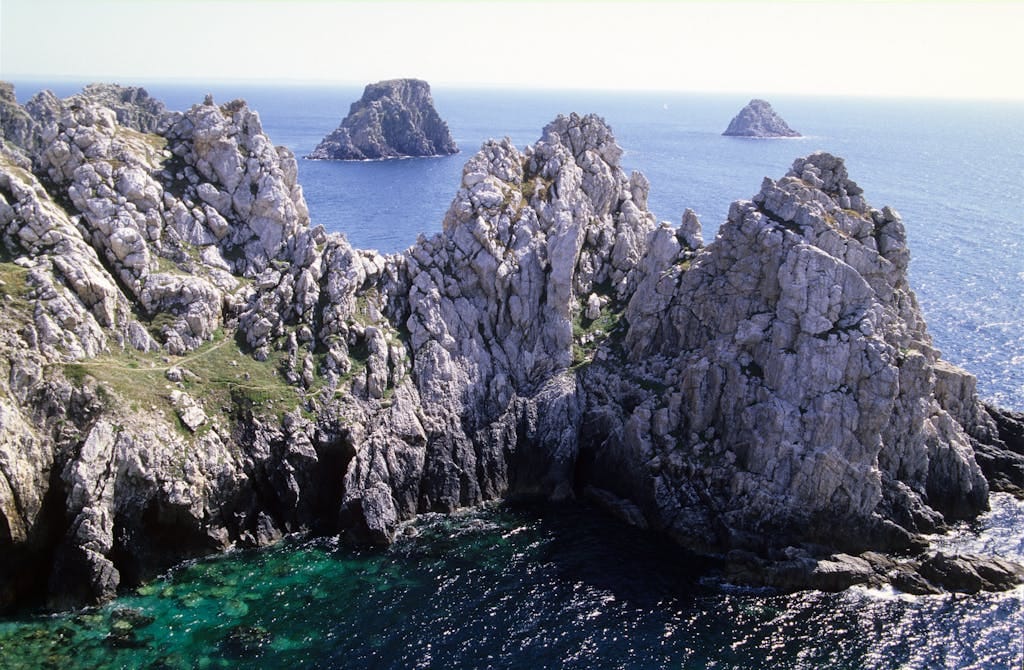 Breathtaking view of the rocky cliffs and azure sea at Crozon, Brittany, France.