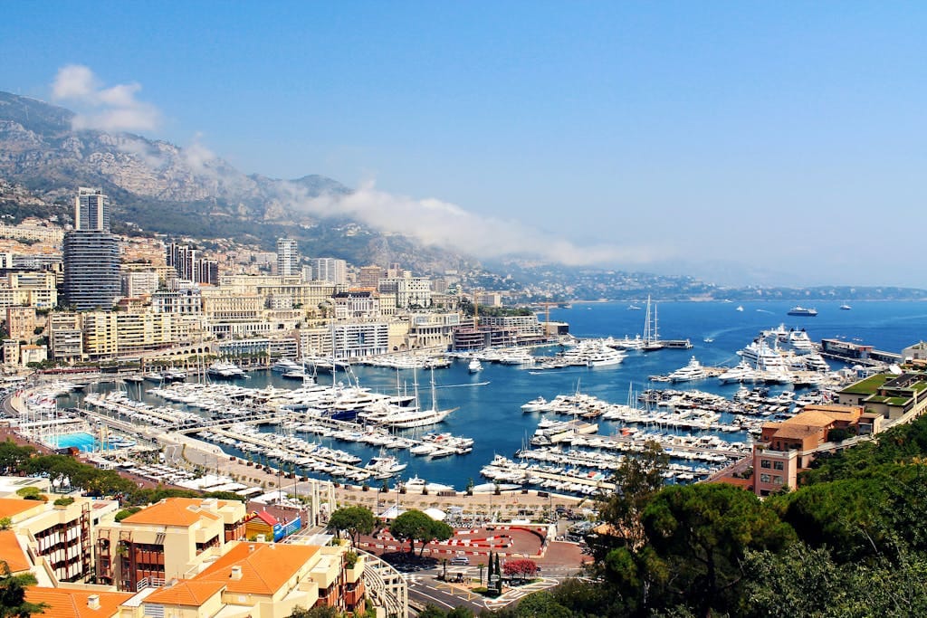 A stunning aerial view of Monte Carlo's marina with yachts and city buildings.